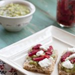 Avocado Verde with red roasted peppers and goat cheese on a whole grain pizza crust